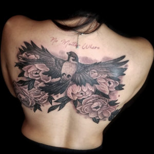 bird and flowers tattoo